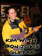 Kim holding Jon Bon Jovi's Guitar